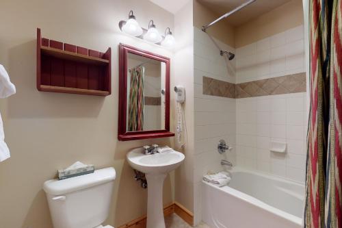 a bathroom with a sink and a toilet and a tub at Copper Springs 426 in Frisco