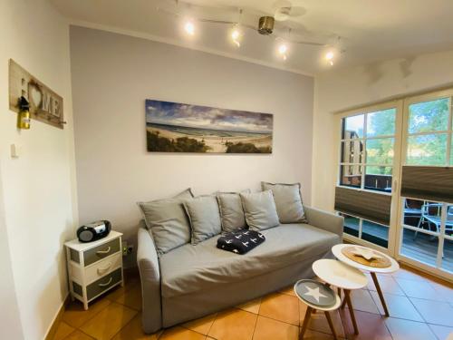 a living room with a couch and a painting on the wall at Haus Hugo in Zingst