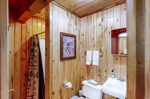a wooden bathroom with a toilet and a sink at Appaloosa Retreat in Pagosa Springs