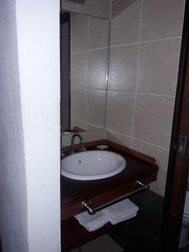 a bathroom with a sink and a mirror at Cabañas El Mirador de Icho Cruz in Villa Icho Cruz