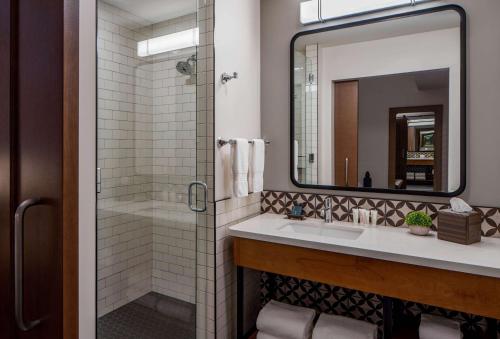 a bathroom with a sink and a mirror at The Last Hotel in Saint Louis