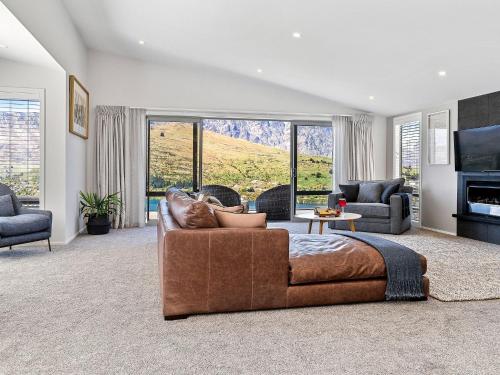 a large living room with a couch and a tv at Highview Haven by Relaxaway Holiday Homes in Queenstown