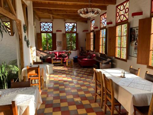 a restaurant with tables and chairs in a room at Terrazas de Salento in Salento