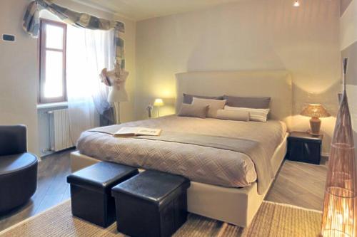 una camera con un grande letto e una finestra di Confortevole appartamento in centro a LA MORRA a La Morra