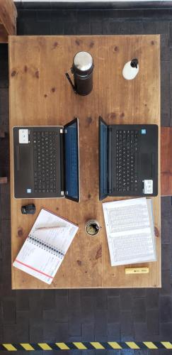 a wooden table with two computers on top of it at Posta del Ángel - Salta in Salta