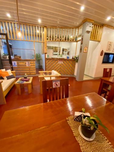 a living room with a table and a couch at Marion Roos Hotel in Puerto Galera