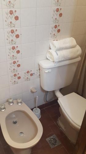 a bathroom with a toilet and a bidet and towels at Posta del Ángel - Salta in Salta