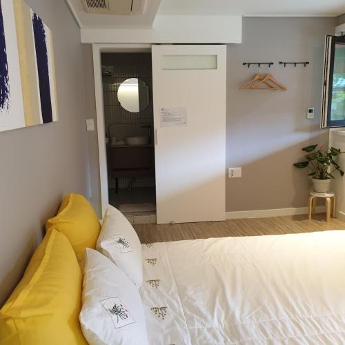 a room with a bed with pillows on it at Haengok Guesthouse in Jeonju