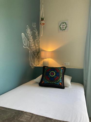 a bedroom with a bed with a pillow on it at El Nido Boutique B&B in Puerto López