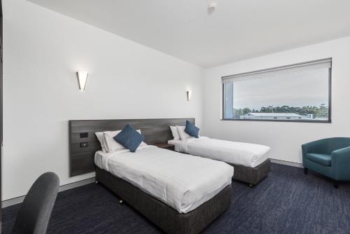 Ein Bett oder Betten in einem Zimmer der Unterkunft Thornton Executive Hotel