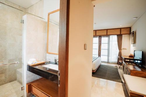 a bathroom with a sink and a shower at Dinara Ubud in Ubud