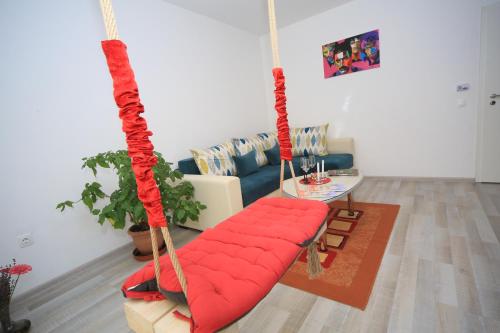 a living room with a red couch and swing at Happy Family in Braşov