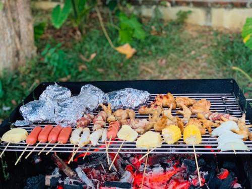 a grill with many different types of food on it at Bavi Annam Garden in Ba Vì