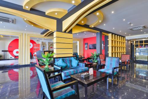 a lobby with blue chairs and a table at Dome Al Sulaimaniah in Riyadh