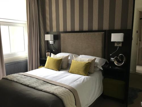 a bedroom with a large white bed with yellow pillows at Hastings House in Hastings