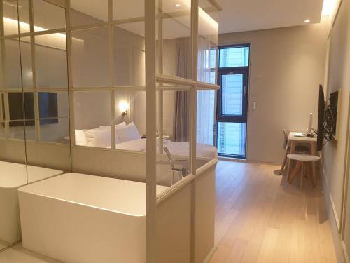 a room with a bedroom with a bed and a mirror at Hotel Libre in Siheung