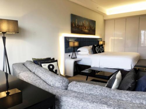 a hotel room with a bed and a couch at M Roof Hotel & Residences in Ipoh