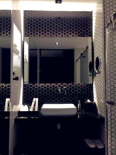 a bathroom with a sink and a large mirror at M Roof Hotel & Residences in Ipoh