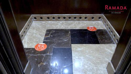 a table with two dice on top of a marble floor at Ramada Plaza by Wyndham JHV Varanasi in Varanasi