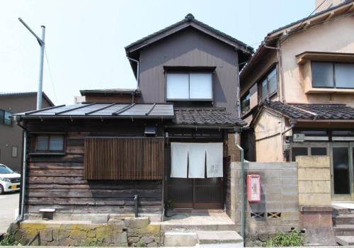 a house with solar panels on the front of it at Hashibaya TABI-NE in Kanazawa