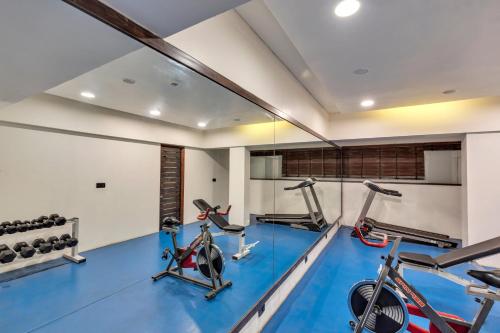 a gym with three exercise bikes in a room at Club Mahindra Saj Mahabaleshwar in Mahabaleshwar