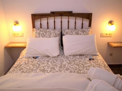 a bed with two white pillows on it at La Casita de Nerea 2 Párking Gratuito in Cuenca