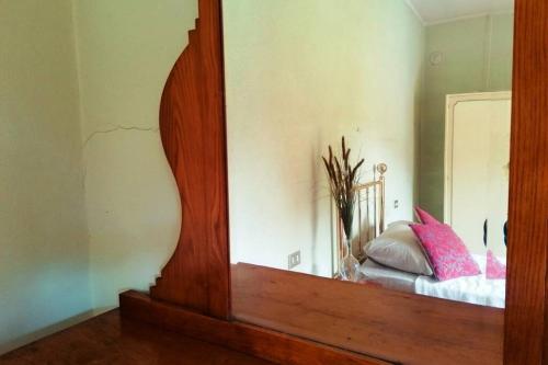 a mirror in a room with a bed in it at Casa di Anita in Bedonia