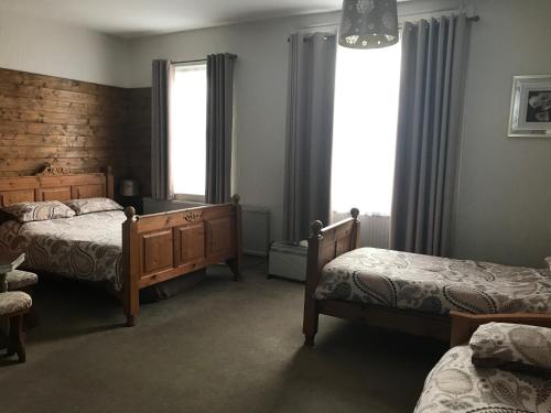 a bedroom with two beds and a window at The Wheatsheaf in Salisbury