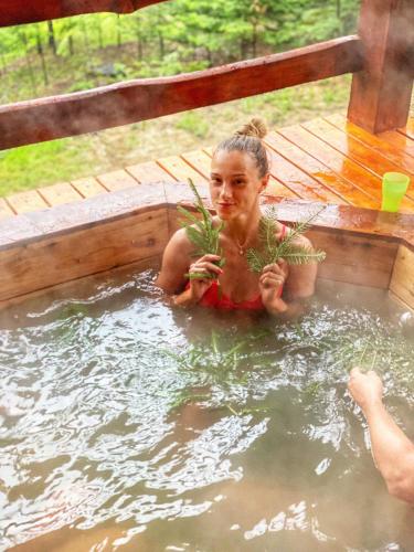 a young girl holding plants in a hot tub at Dachna Sadyba PB in Migovo