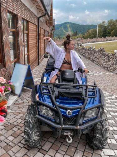 a woman sitting on a atv vehicle at Dachna Sadyba PB in Migovo