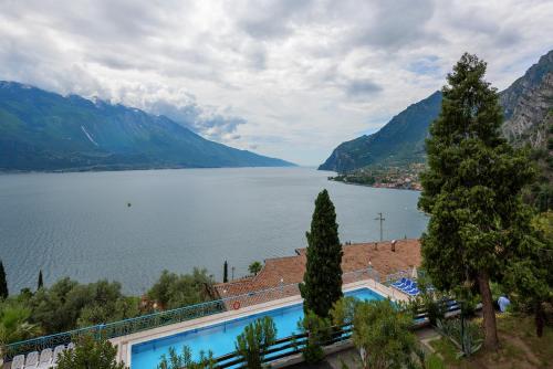a large body of water surrounded by mountains at Centro Vacanze La Limonaia in Limone sul Garda