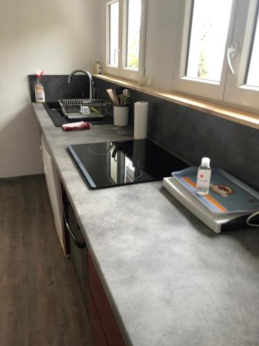 a kitchen with a sink and a counter top at LOGEMENT PERIGUEUX in Champcevinel