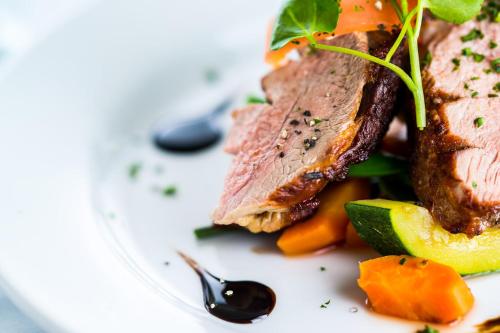 a plate of food with meat and vegetables on it at Amberley Inn in Stroud