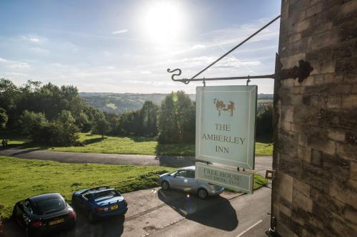a sign for the antwerp inn with cars parked at Amberley Inn in Stroud