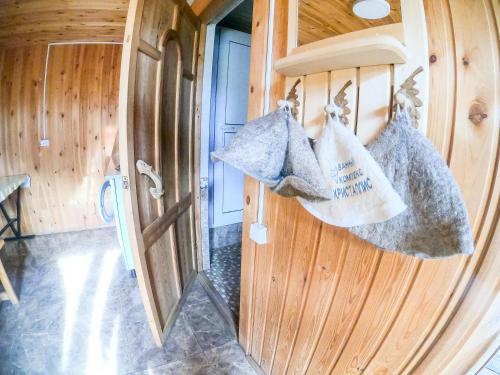 a door to a room with bags hanging on a wall at Alakol-Jyrgalan Guest House in Dzhergalan