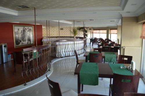 a dining room with tables and chairs in a restaurant at Nobel Hotel Ankara in Ankara