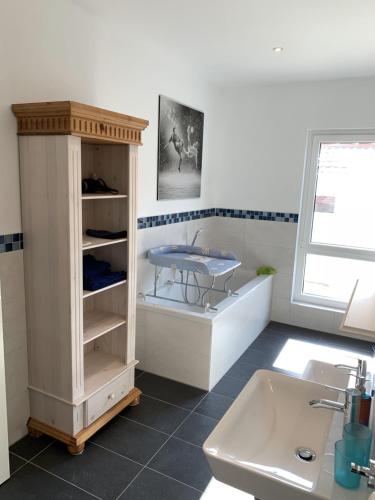 a bathroom with a sink and a table in it at Ferienhaus „Linde 1“ in Winsen Aller