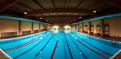 an indoor swimming pool with a large pool at River Palace Hotel in Atyraū