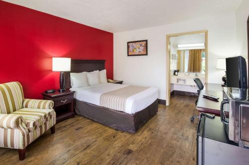 a hotel room with a bed and a chair at Econo Lodge Marion I-81 in Marion
