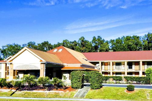a large building with a red roof at Quality Inn near Manatee Springs State Park in Chiefland