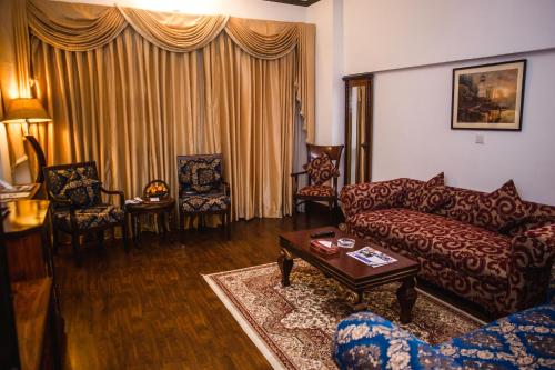 a living room filled with furniture and a couch at Hotel Mehran in Karachi