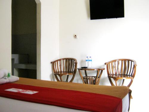 a counter with two chairs and a table with a mirror at Aqilakost Gadog Puncak Bogor in Bogor