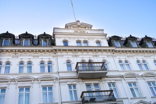 a large white building with a balcony on it at Elite Hotel Mollberg in Helsingborg
