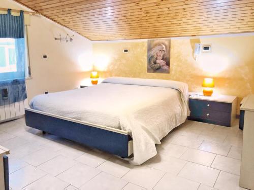 a bedroom with a large bed and two night stands at Tiziana in Giardini Naxos