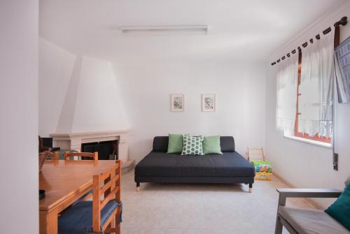 a living room with a bed and a table at Villa Zambujeira do Mar Family & Friends in Zambujeira do Mar