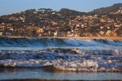 a view of the beach with a city in the background at Hotel Arce in Baiona