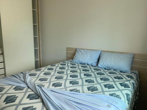 1 dormitorio con 1 cama con almohadas azules en CASA NO CENTRO, en Itapema