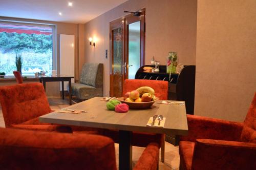 a room with a table with a bowl of fruit on it at Sonnenhof-Willingen in Willingen