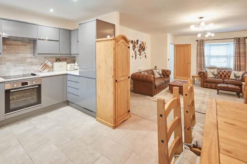 a kitchen and living room with a table and chairs at Host & Stay - No 5 Hoggarths Yard in Whitby
