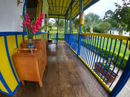 a balcony with a vase of flowers on a table at El Rancho de Salento in Salento